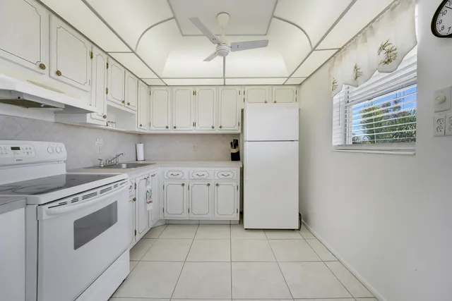 a kitchen with cabinets and white appliances