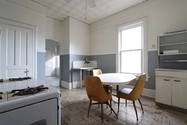 a dining room with furniture and window