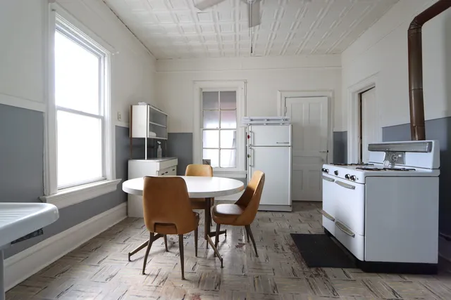 a dining room with furniture and window