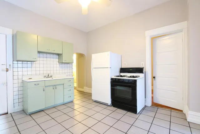 a kitchen with a stove sink and cabinets