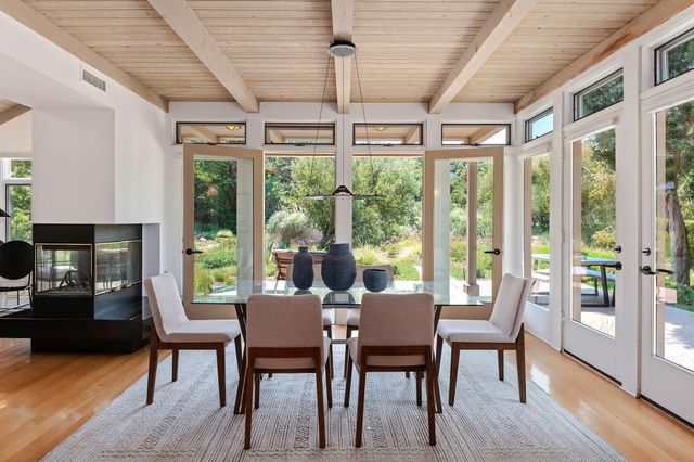 a dining room with furniture a chandelier and wooden floor