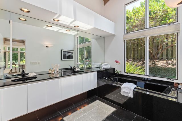 a large kitchen with a large window and stainless steel appliances