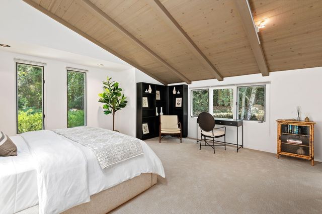 a spacious bedroom with a large bed and a large window