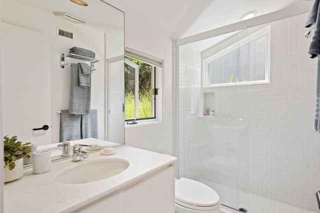 a bathroom with a sink toilet and shower