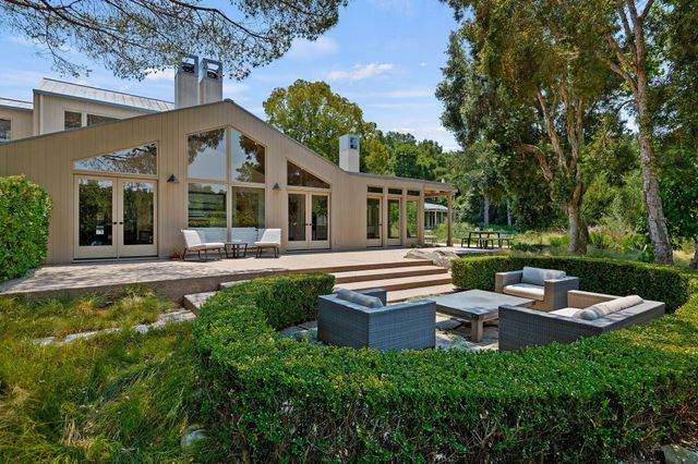a front view of a house with garden and porch