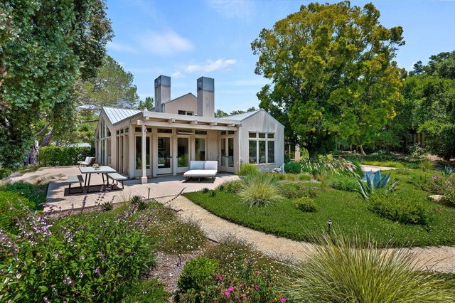 a view of a backyard with table and chairs and a fire pit