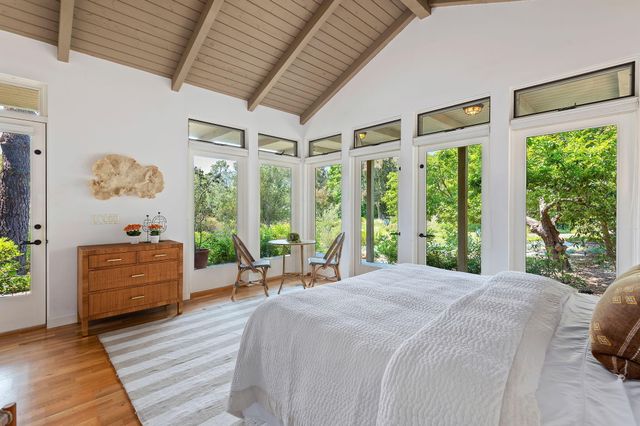 a view of a porch with chairs and backyard
