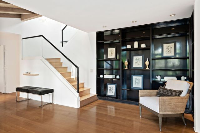 a living room with furniture and a book shelf