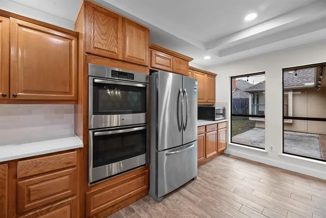 a kitchen with granite countertop stainless steel appliances and counter space