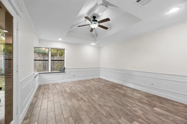 wooden floor in an empty room with a window