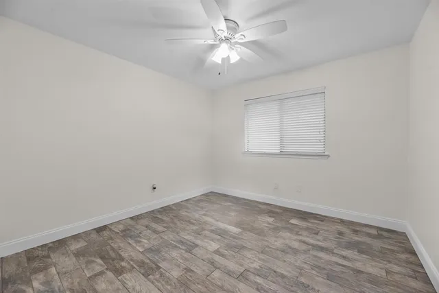 wooden floor in an empty room with a window