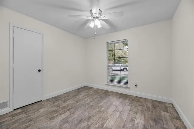 wooden floor in an empty room with a window
