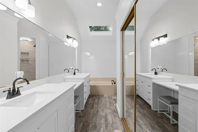 a spacious bathroom with a double vanity sink mirror and toilet