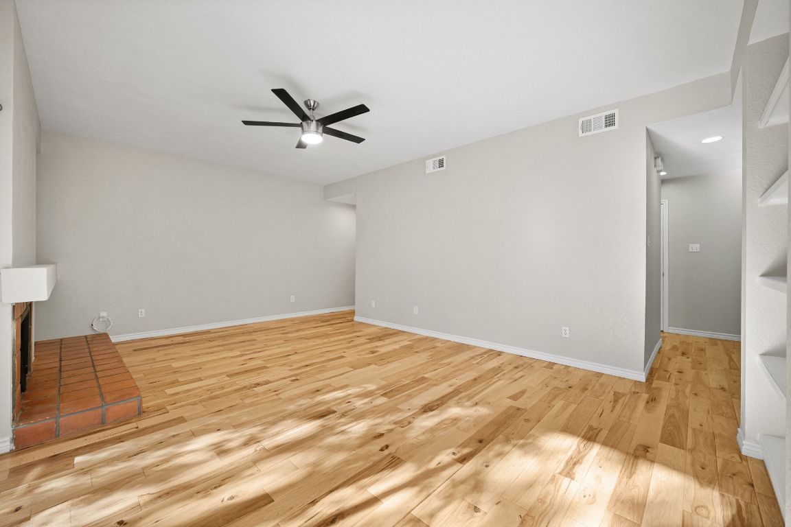4711 Spicewood Springs Road, Unit 2107 Austin, TX 78759 - Photo 11 of 26 a view of a livingroom with a ceiling fan and wooden floor