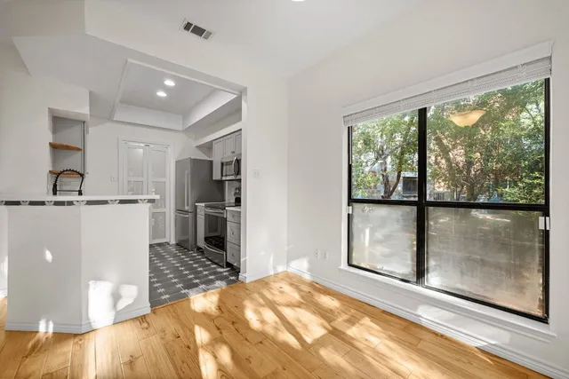 a bedroom with a bed and a large window