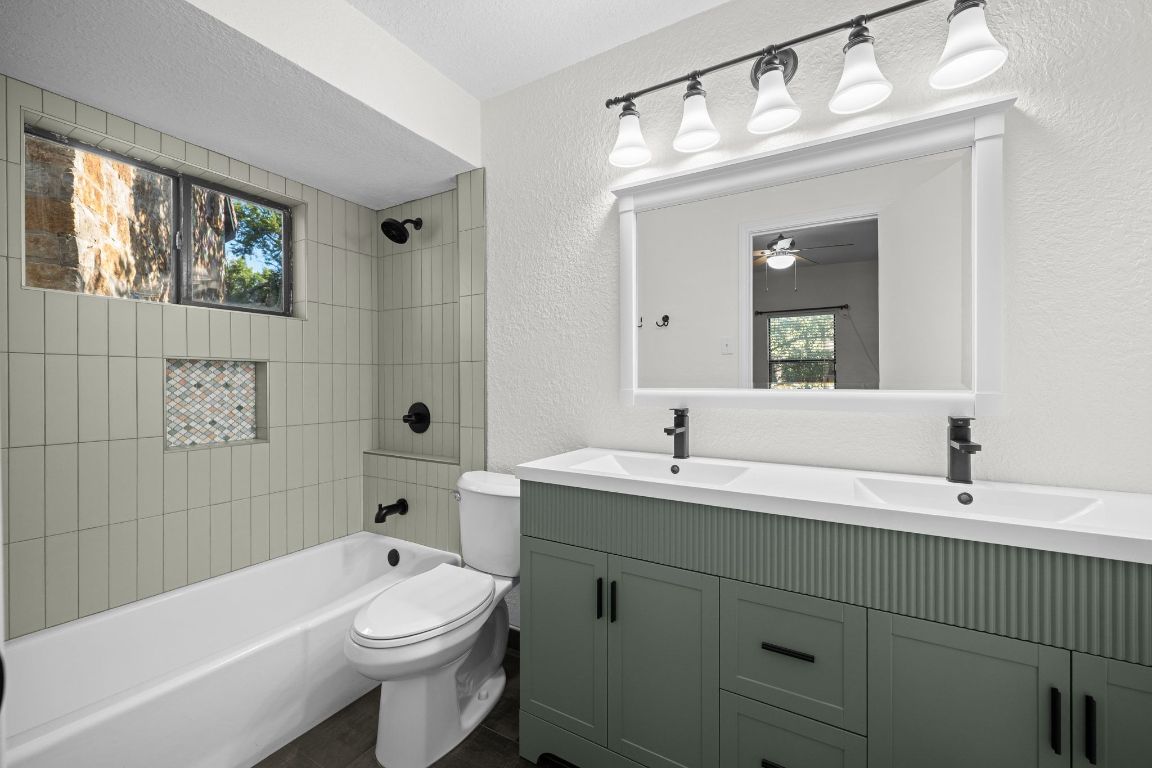 4711 Spicewood Springs Road, Unit 2107 Austin, TX 78759 - Photo 20 of 26 a bathroom with a toilet a sink a mirror a bathtub and vanity