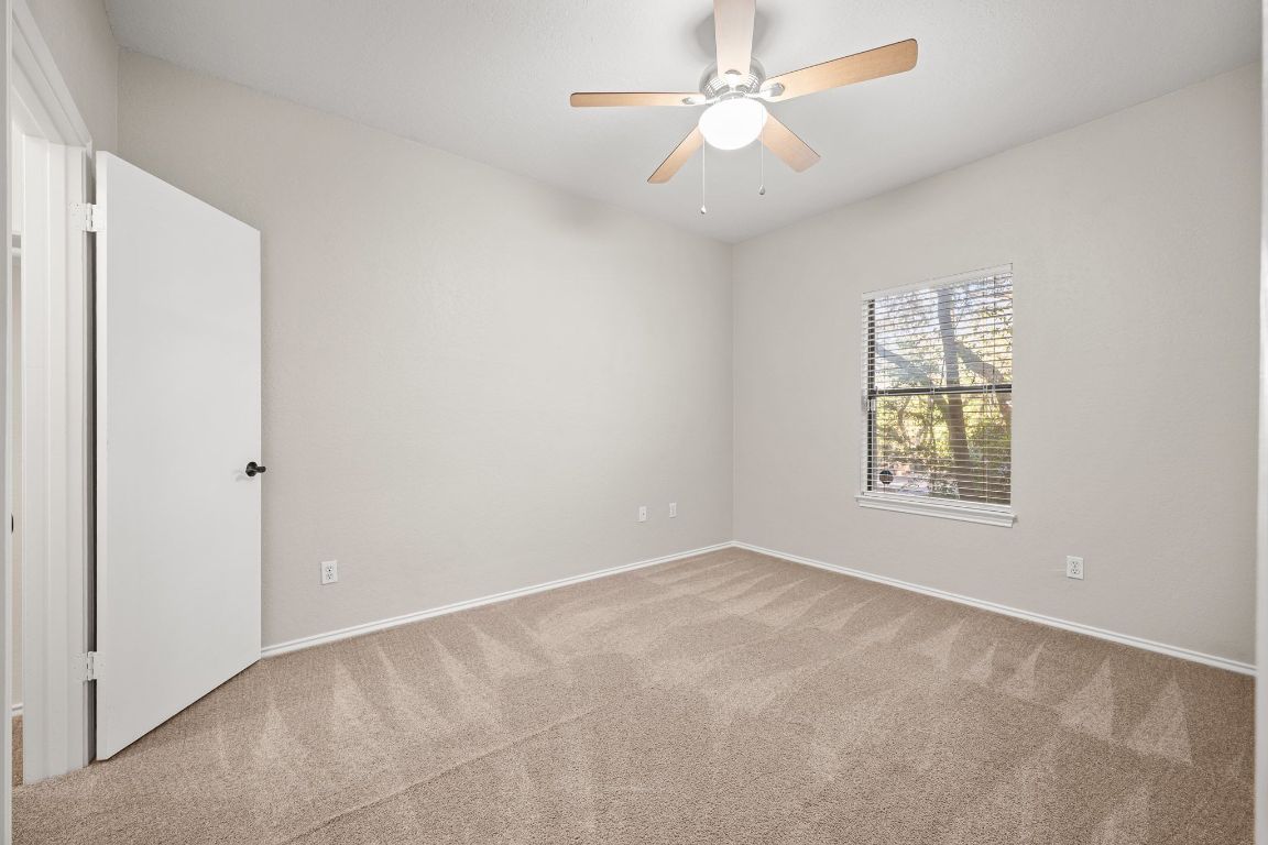 4711 Spicewood Springs Road, Unit 2107 Austin, TX 78759 - Photo 21 of 26 an empty room with a window and a fan