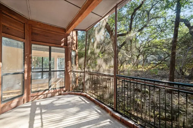 a view of balcony with floor to ceiling windows and wooden fence
