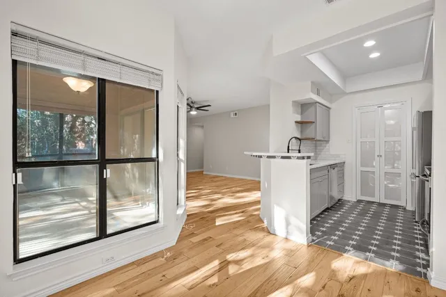 a view of a kitchen with a sink and refrigerator