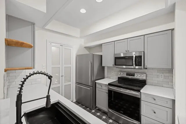 a kitchen with a refrigerator stove and microwave