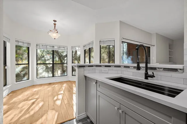 a view of a double sink and a large window in the room