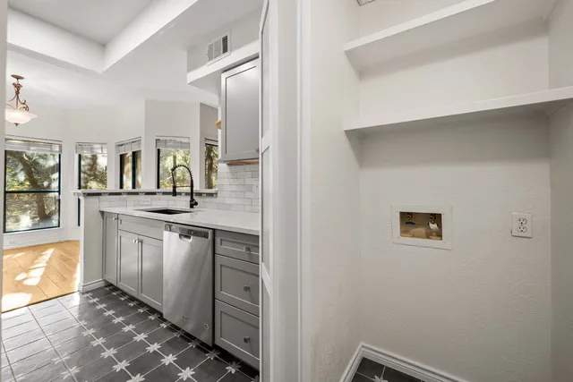 a kitchen with a sink and cabinets