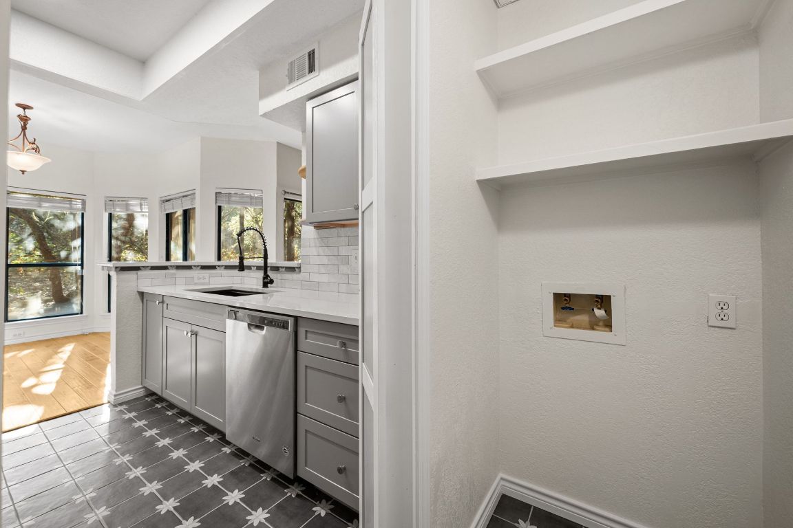 4711 Spicewood Springs Road, Unit 2107 Austin, TX 78759 - Photo 7 of 26 a kitchen with a sink and cabinets