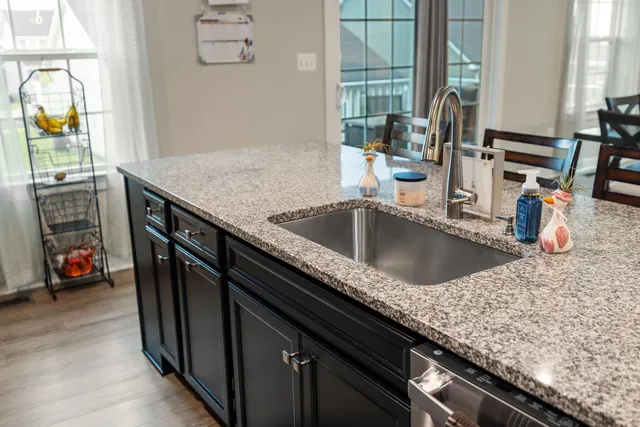 a large kitchen with stainless steel appliances lots of counter space and breakfast area