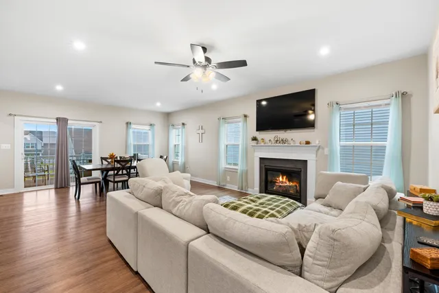 a living room with furniture a fireplace and a flat screen tv