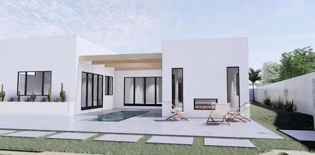 a view of house with yard and sitting area