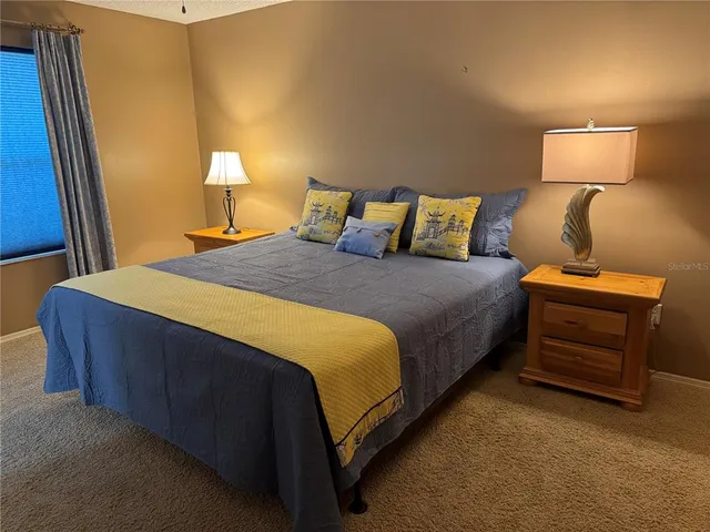 a bedroom with a bed and a lamp