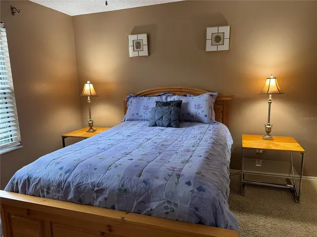 a bedroom with a bed and a lamp