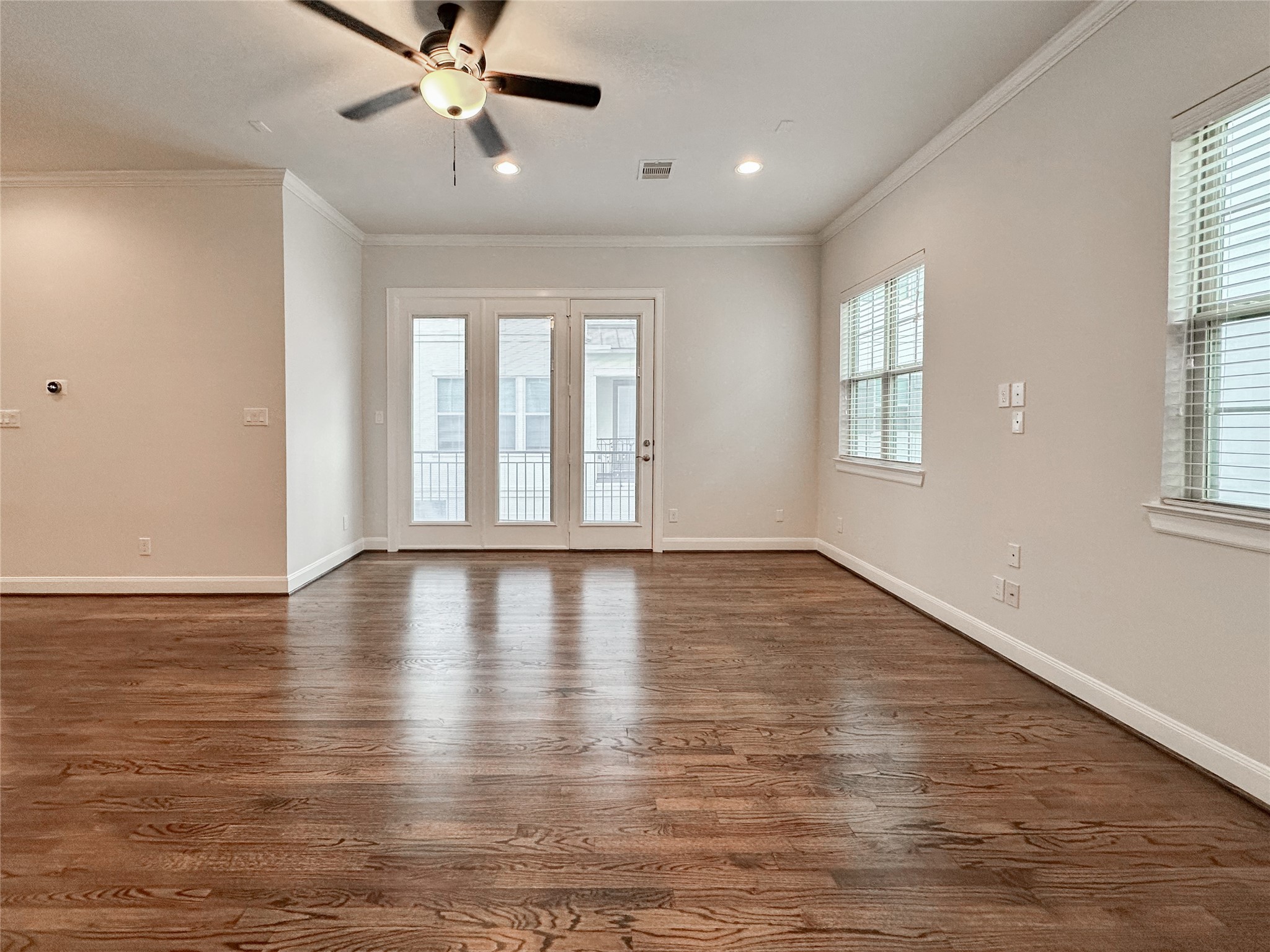 10 Hermann Park Court Houston, TX 77021 - Photo 13 of 32 a view of an empty room with wooden floor and a window