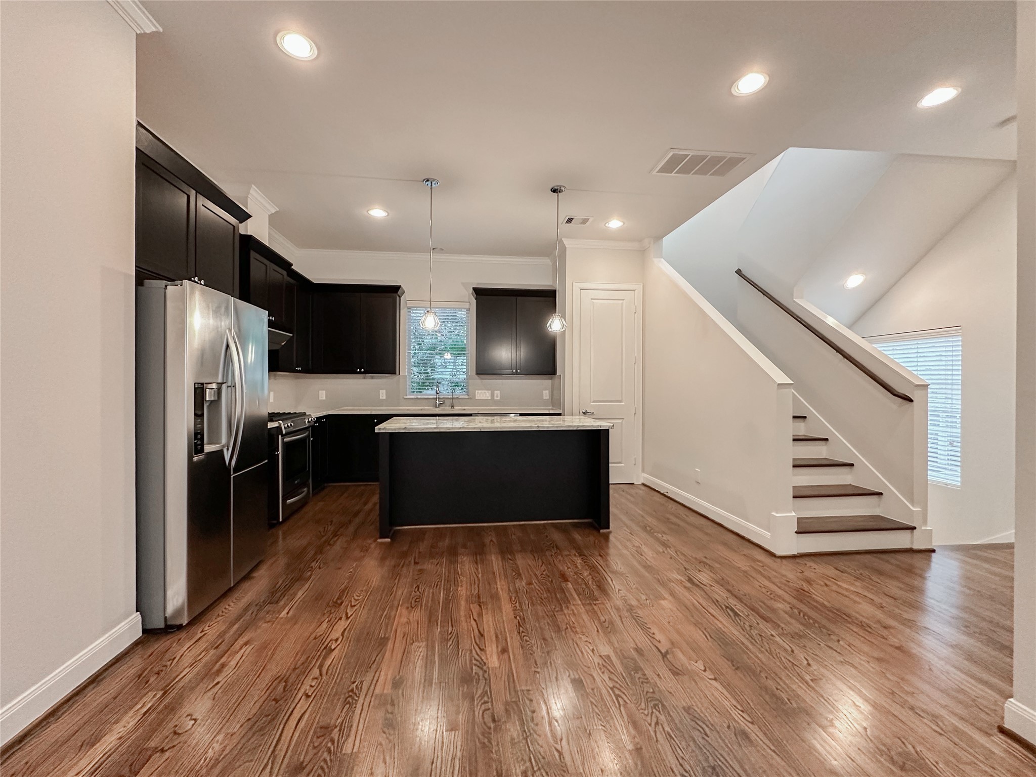 10 Hermann Park Court Houston, TX 77021 - Photo 15 of 32 a large kitchen with stainless steel appliances kitchen island a large counter top and a refrigerator
