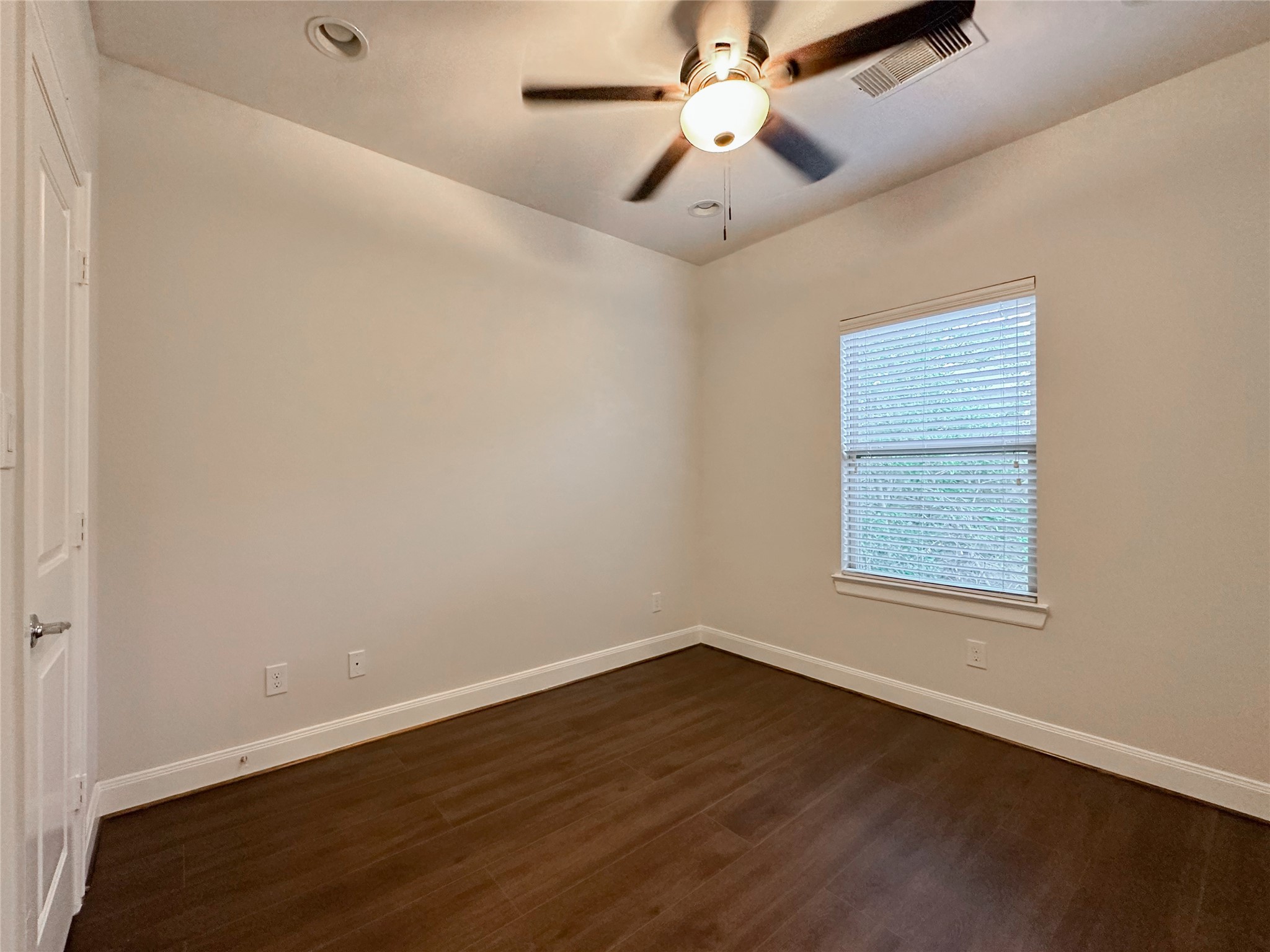 10 Hermann Park Court Houston, TX 77021 - Photo 23 of 32 an empty room with wooden floor fan and windows