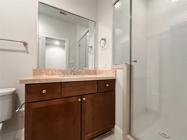 a bathroom with a sink vanity and a mirror