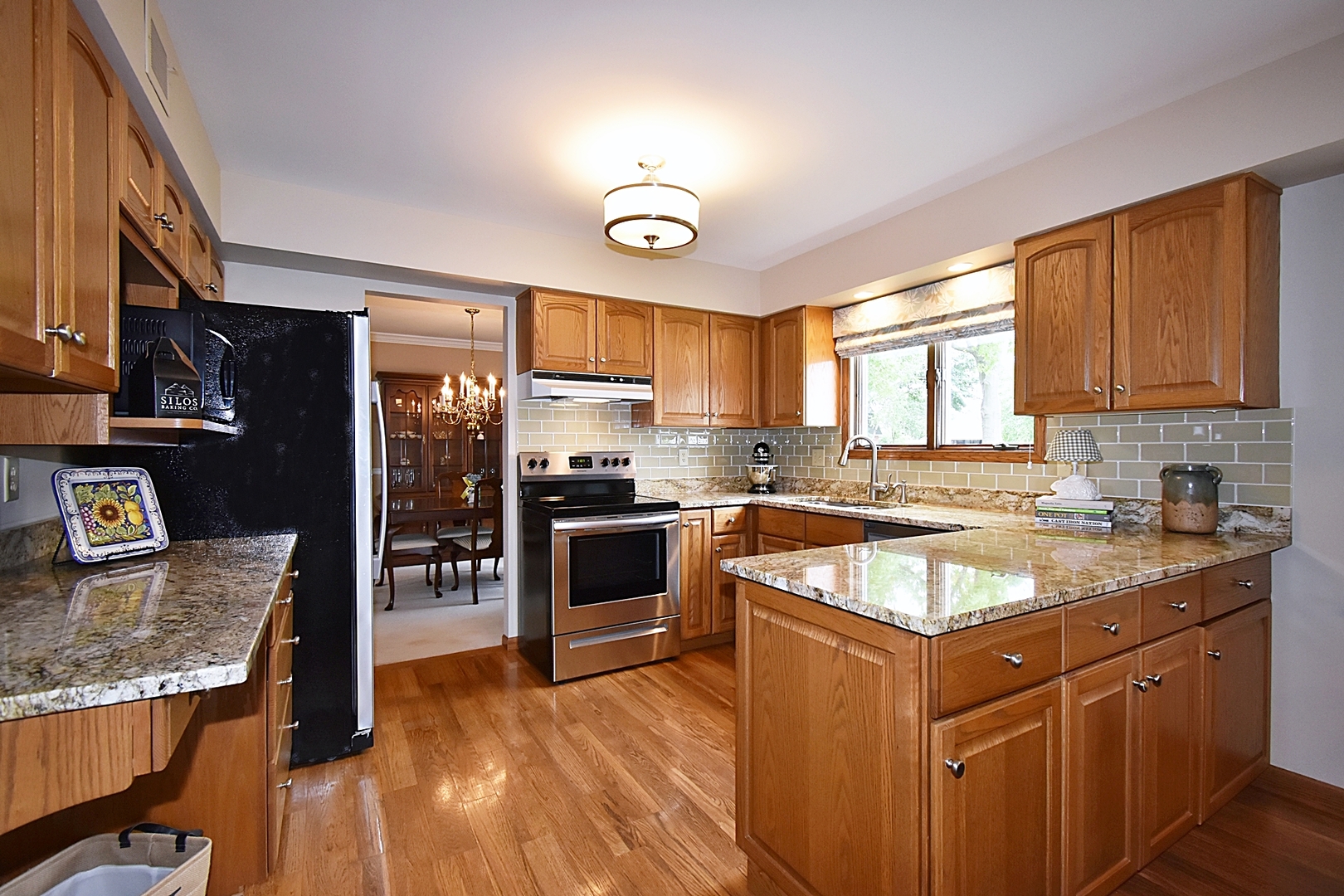 29 Manchester Way Aurora, IL 60506 - Photo 13 of 38 a kitchen with stainless steel appliances granite countertop a sink stove and refrigerator