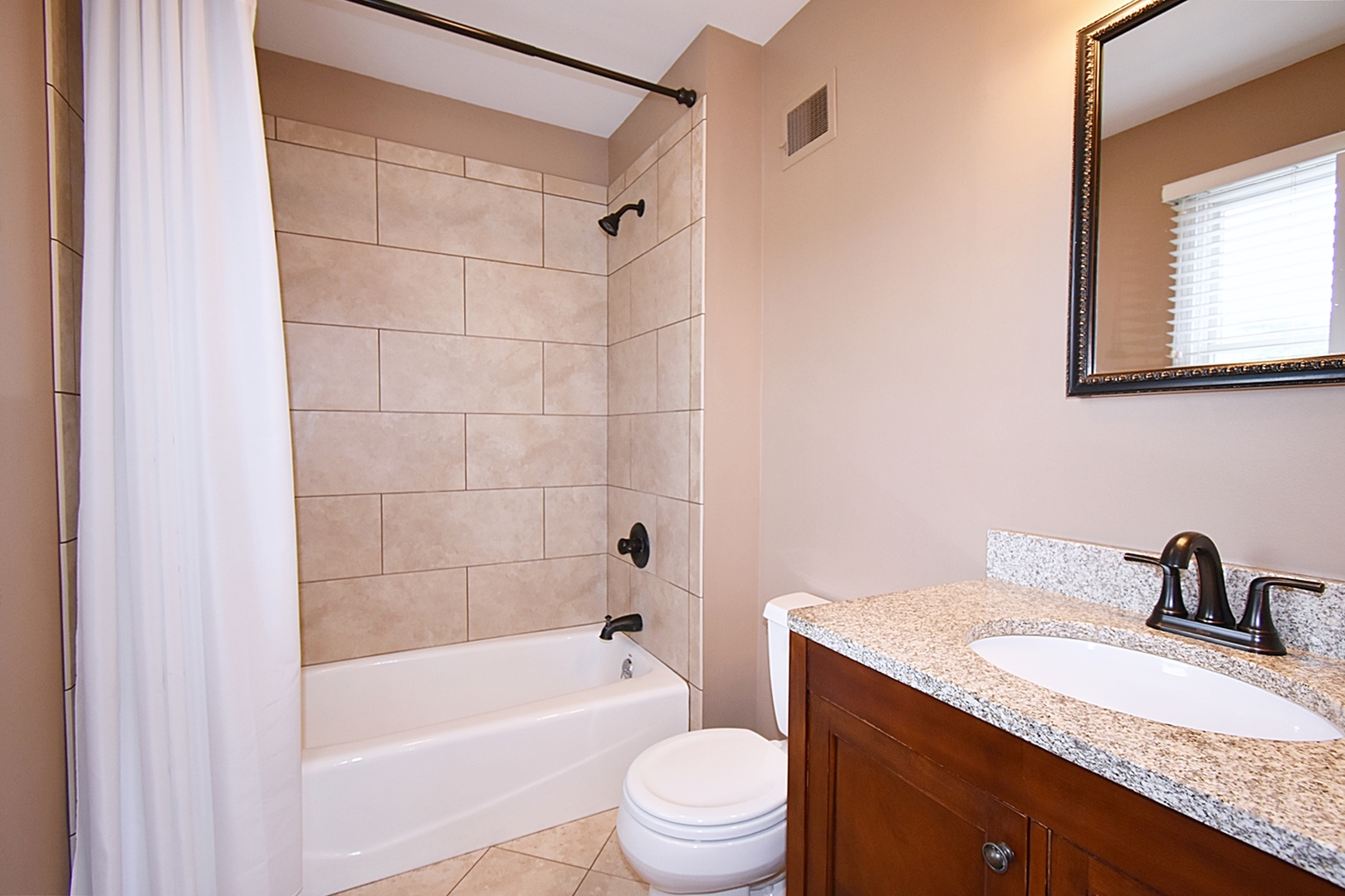 29 Manchester Way Aurora, IL 60506 - Photo 23 of 38 a bathroom with a granite countertop sink a toilet a mirror a vanity and shower