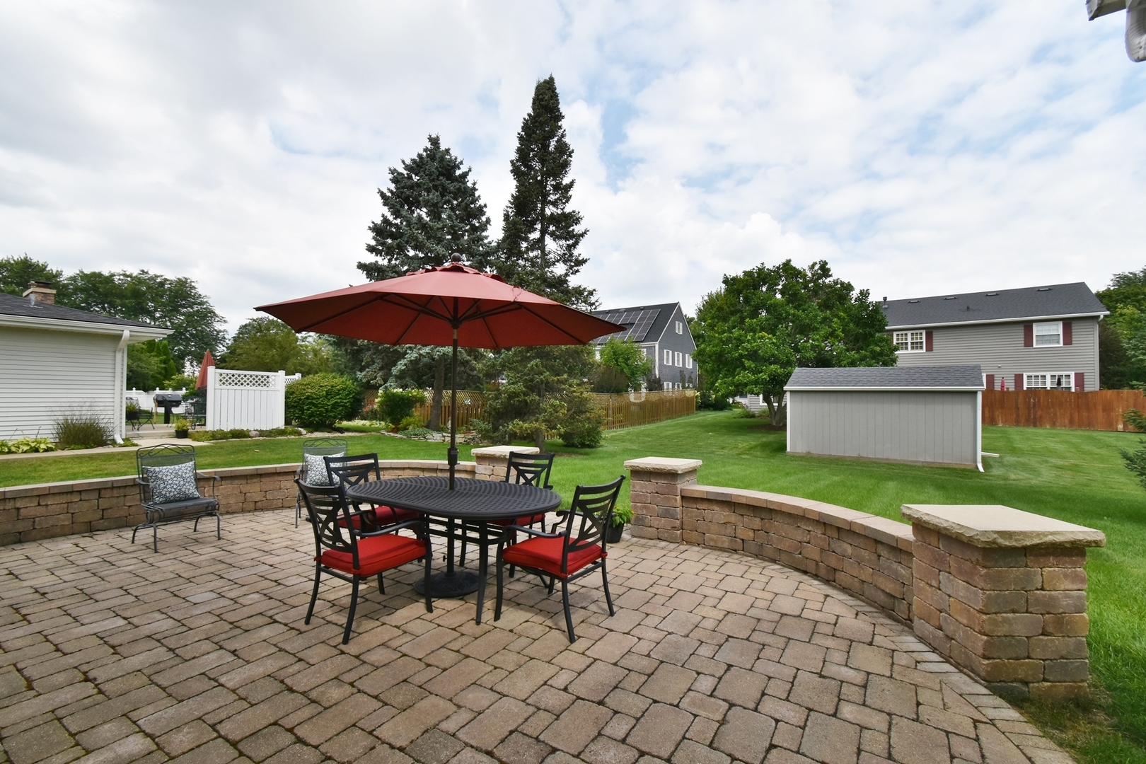 29 Manchester Way Aurora, IL 60506 - Photo 37 of 38 a view of a table and chairs under an umbrella in backyard