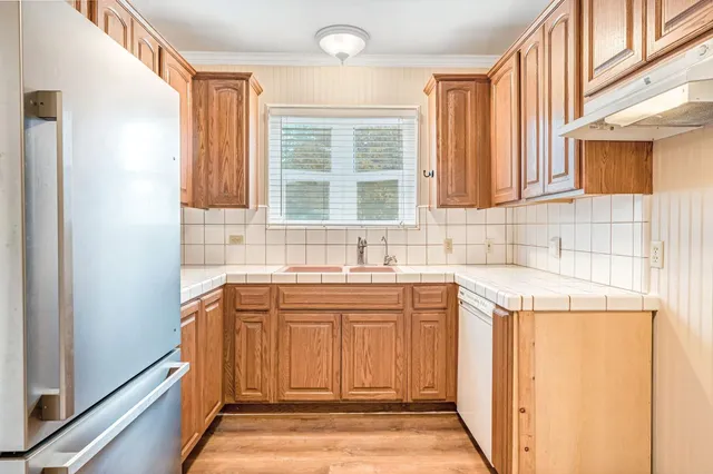 a kitchen with a sink stove and cabinets
