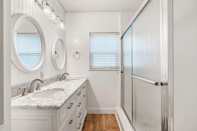 a bathroom with a granite countertop sink mirror and vanity