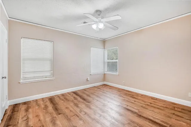 wooden floor in an empty room with a window