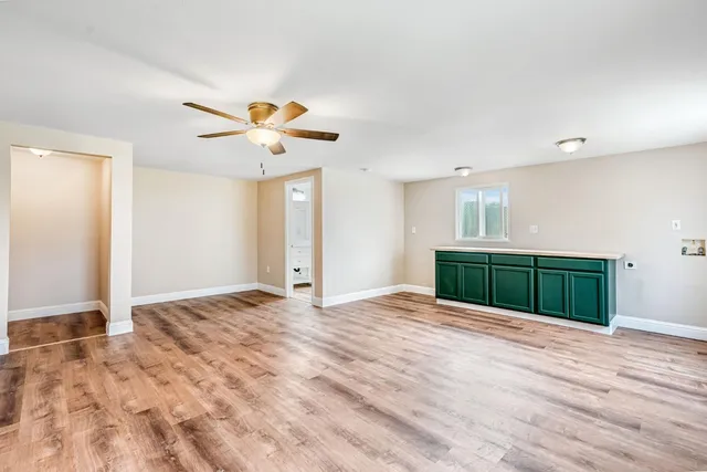 a view of an empty room with a ceiling fan