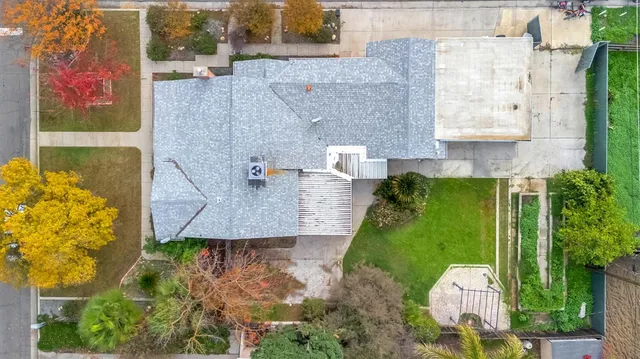 an aerial view of a house with a yard