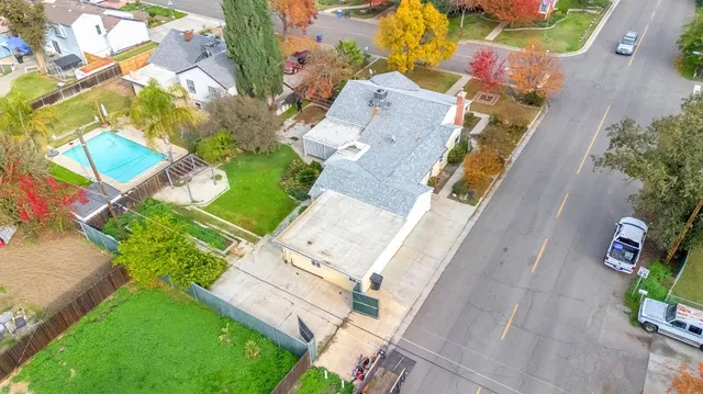 an aerial view of a house with a garden and swimming pool