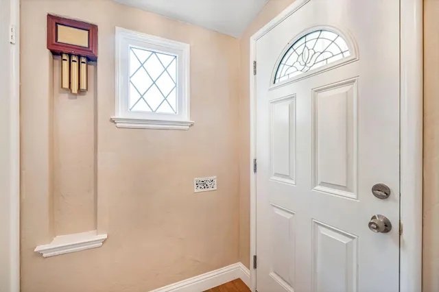 a view of front door with a mirror