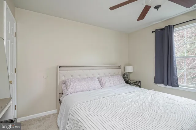 a bedroom with a large bed and a window