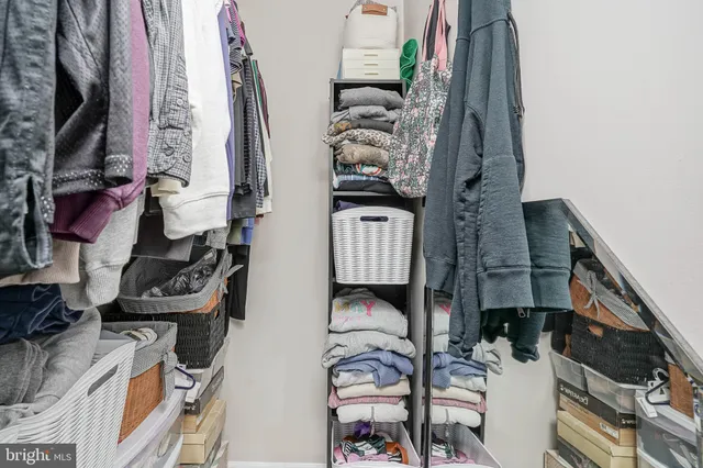 a view of walk in closet with clothes