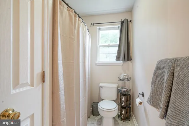 a white toilet sitting next to a bathroom sink