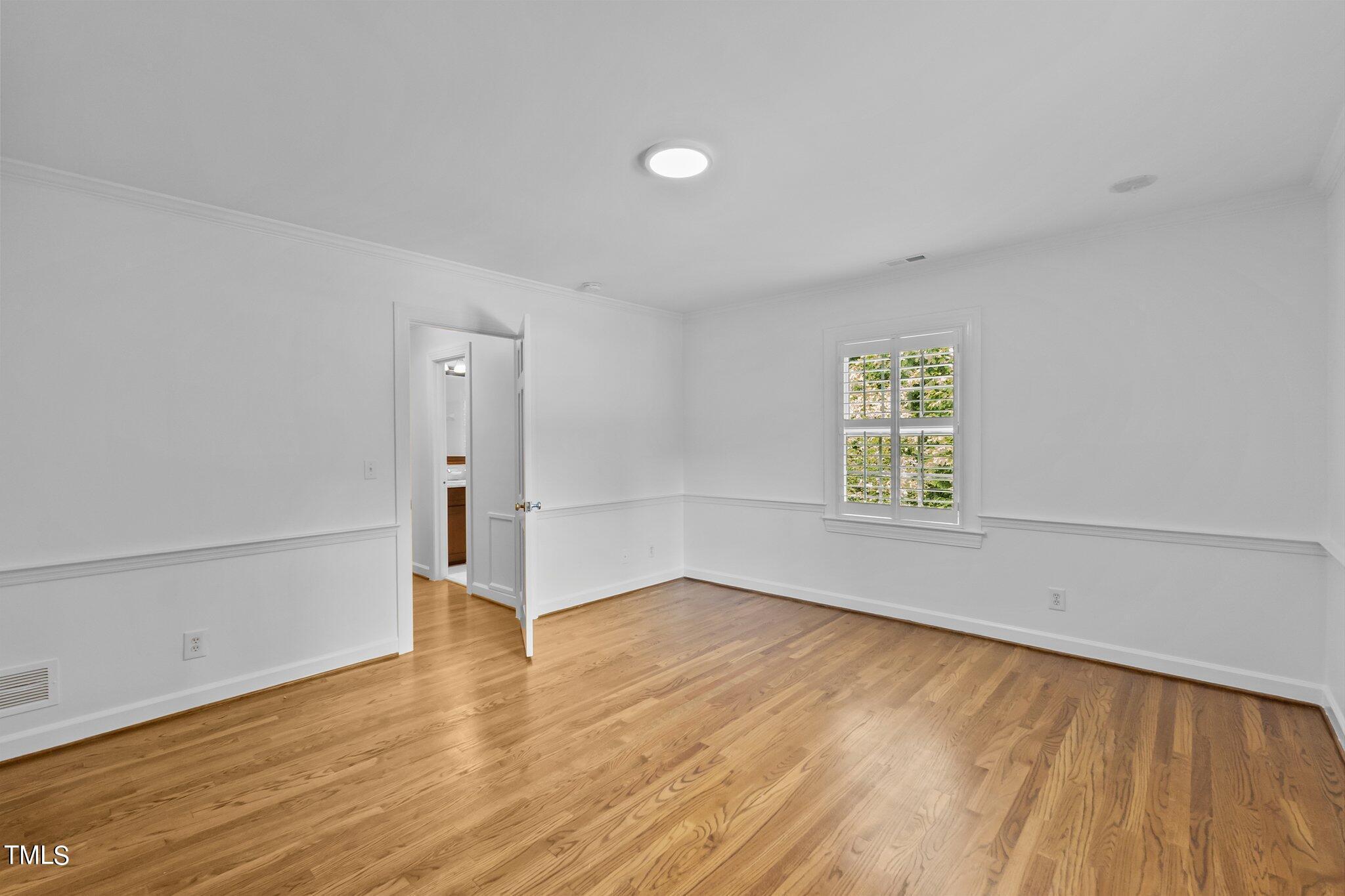 1817 Stillwater Drive Raleigh, NC 27607 - Photo 23 of 58 wooden floor in an empty room with a window